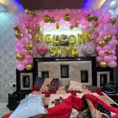 A simple yet beautiful bedroom decoration to welcome baby Siya. This setup includes a pink and gold balloon arch over the bed with foil balloons spelling out the baby's name. I can personalize any decoration with your baby's name.