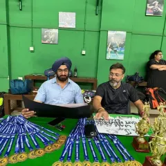 Preparing for the awards ceremony. Our coaches are organizing the medals and trophies for the summer camp's internal tournament.