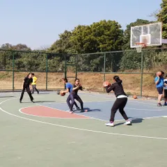 Teamwork and communication are at the heart of our girls' training sessions. Here, players are engaged in a passing drill, learning to create space and execute precise passes to their teammates.