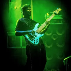 Our bassist, bathed in green light, laying down the solid foundation of our groove.