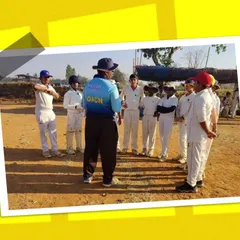 A coach addressing his team during a practice match at our summer camp. We focus on instilling teamwork and sportsmanship from a young age.