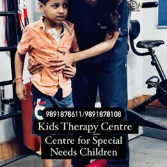 We are a dedicated therapy center for children with special needs. Here, a therapist assists a child with balance and walking on an uneven surface, an exercise designed to improve his motor skills and confidence.