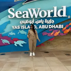 Posing at the entrance of SeaWorld. This neutral-toned jumpsuit is a great travel staple as it can be styled in many different ways.