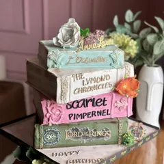 Turning pages and turning heads. This vintage books-themed cake is a story in every bite, featuring edible versions of favorite novels like 'Lord of the Rings' and 'Persuasion'.
