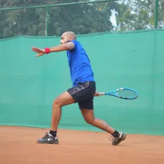 A player demonstrates perfect form during a forehand drill. Our coaching emphasizes progress over perfection, focusing on building solid technical fundamentals.