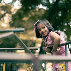 A candid shot of my niece playing on the monkey bars. My approach to kids' photography is to let them play and explore, capturing their natural curiosity and joy.