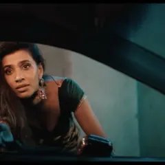 A still from the same Infinix campaign, featuring another character. Her costume, with traditional jhumka earrings and a simple blouse, was designed to create a visual and emotional contrast with the urban setting and the other characters.
