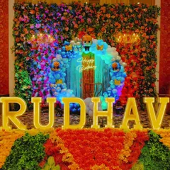 A close-up of the high-impact flower wall backdrop. The combination of a dense floral base, an inset balloon circle, and glowing neon and marquee letters creates a luxurious and multi-layered look.