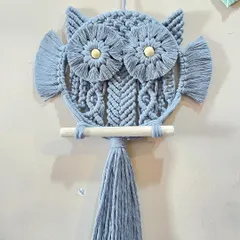 This dusty blue macrame owl shows the intricate knotting I use to create the texture of the feathers on its belly. Each owl is handcrafted with eco-friendly cotton cord.