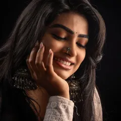 Another shot from the same studio session, this time with a smile. It shows how the makeup looks soft and natural even with dramatic, single-light photography.