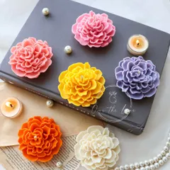 My floating Camellia candles are a simple way to add elegance to any space. This photo showcases the new shades I've added to the collection, from soft pinks and oranges to a classic ivory, all ready to float in your festive bowl.