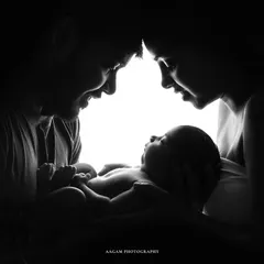 A similar silhouette style, capturing the profiles of mom and dad as they admire their newborn. These are the moments that become your legacy.