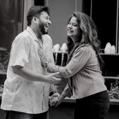 A black and white candid shot from a pre-wedding session. Sometimes, the simplest moments of shared laughter make for the most timeless photographs.