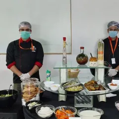 Our professional chefs in uniform, ready to serve at a corporate event. Their expertise and courteous service are a key part of the Brunch N Bite experience.