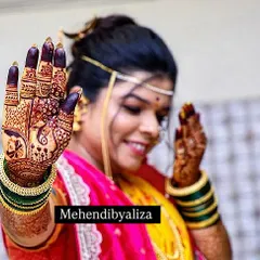 A happy bride showing off her dark stained henna. A beautiful smile and a beautiful stain, what more could an artist ask for?