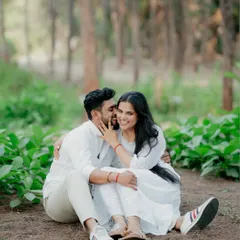 A playful and intimate moment in the woods, with the groom-to-be whispering in his partner's ear as she laughs. This candid shot is full of personality and love.