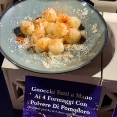 Handmade Gnocchi Ai 4 Formaggi. Our soft, pillowy potato gnocchi is served in a rich four-cheese sauce and dusted with tomato powder for a touch of acidity.