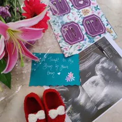 We also make happy feet for the little ones. These adorable red crochet booties with a white bow are soft, warm, and perfect for a baby's delicate feet.