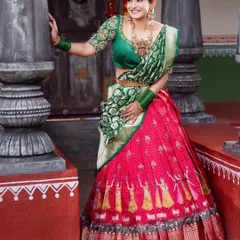 A timeless look for any traditional function. This classic silk Langa Voni, with its rich red skirt and contrasting green blouse and dupatta, is a favorite for festive events and family gatherings.