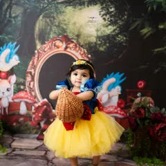 This little princess is ready for a walk through the woods with her basket. The Snow White theme is a timeless choice for a magical birthday or milestone shoot.
