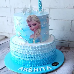 Let it go! This two-tier Frozen-themed cake is perfect for any little princess. The bottom tier features a beautiful ruffle design, while the top showcases Elsa. We made this with two different flavors, Belgian chocolate and fruit, to please all the guests.