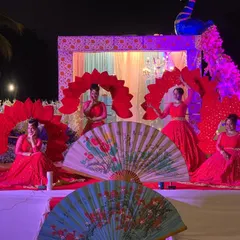 A beautiful Varmala ceremony setup in Mysore, featuring our dancers in red costumes with large fan props. We create a stunning visual backdrop for the couple's most important moments.