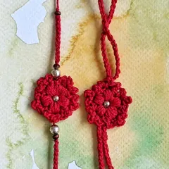 A matching set of red floral crochet Rakhi and Lumba. These are perfect for celebrating the bond with both your brother and sister-in-law, featuring intricate petal work and bead accents.