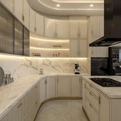 A kitchen designed for those who love to cook. We conceptualized this space with a sweeping curved counter, marble-patterned backsplash, and a neutral color theme, enhanced by integrated lighting and gold PU grooving for a truly luxurious feel.