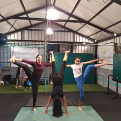 A great display of strength and flexibility from three of my students. One holds a steady handstand while the other two perform standing splits, all working together on the mat.