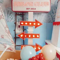 Light-up directional arrows and themed signage guided guests through the different areas of the sailor-themed celebration.