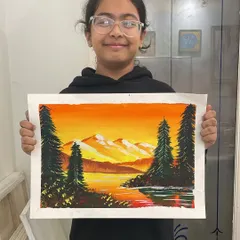 A young student holds up her poster color landscape painting of a mountain sunset. She did a wonderful job blending the warm colors of the sky and reflecting them in the water.