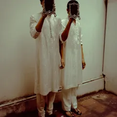 A conceptual shot for designer Sanchit Sharma, where models hold ornate mirrors obscuring their faces. This image plays with ideas of identity and reflection, creating a surreal and thought-provoking fashion narrative.
