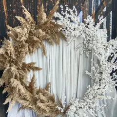 A unique and artistic backdrop combining two different textures. One half of the ring is decorated with earthy pampas grass, while the other half features delicate white cherry blossoms.
