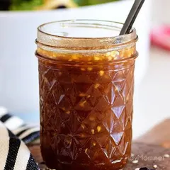 A jar of my Asian Honey Sesame dressing. The texture from the sesame seeds and minced ginger is visible, promising a punch of flavour.