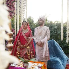 Priyanka and Ashish during their daytime wedding rituals. The mandap is adorned with cascading white florals, creating a serene and beautiful atmosphere for the sacred ceremony.