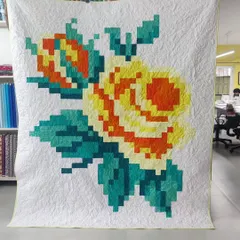 Another take on the pixelated rose, this time in warm yellows and oranges. The intricate quilting adds texture and makes the design pop.