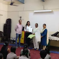 Receiving a certificate of appreciation after conducting a session for students on legal careers.