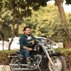 This is a duplicate of image 1, showing a close-up portrait of the rider on his Harley. It emphasizes the connection between the rider and his machine.