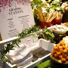 The details matter. A custom-printed menu for a grazing station clearly lists the curated selection of cheeses, cold cuts, and accompaniments like fig chutney and smoked honey, reflecting the thoughtful and bespoke nature of my service.