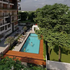 From this elevated angle, you can see the layout of the entire pool area. The design ensures ample space for lounge chairs and socialising, while the surrounding green lawn provides a soft, natural border. It’s a practical and beautiful solution for community living.