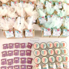 An overhead view of the baby shower gift sets, showcasing the beautiful net wrapping and personalized thank you cards for Nidhi's special day.