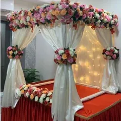 This multi-color floral canopy shows how you can blend different shades for a rich and festive look. The combination of pink, peach, and cream roses on a white fabric frame offers a grand and celebratory feel.