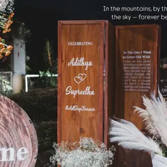 We love planning pre-wedding celebrations at stunning destinations like Wayanad. Here, the couple poses against a rustic-chic decor setup we created, with the mountains and lake providing a spectacular natural backdrop.