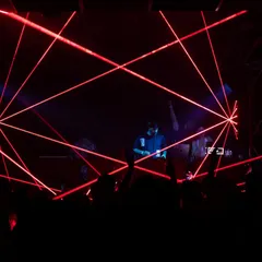 The connection with the crowd is everything. This shot, with the lasers cutting through the dark, shows that moment of shared energy between the DJ booth and the dancefloor.