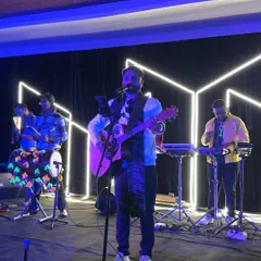 A full band performance on a neon-lit stage for a New Year's Eve event. We bring a professional setup and high energy to make large-scale celebrations truly special.