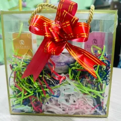 Another look at one of our custom gift hampers, complete with a beautiful red bow. We can create these for bulk orders or individual needs, all within your budget.