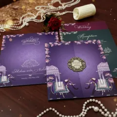 I designed this invitation suite to evoke a sense of royal celebration. The deep purple card features majestic elephant illustrations and traditional dome motifs, complemented by a custom laser-cut monogram. The set includes separate inserts for the wedding and reception.