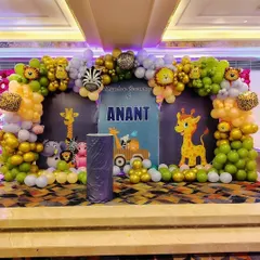 A close-up of the jungle-themed stage for Anant's Mundan ceremony, showing the detailed balloon arch and custom backdrop.
