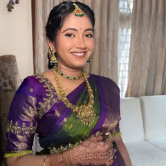 A bright and happy portrait from a Seemantha ceremony. The makeup enhances her natural glow, and the traditional attire makes for beautiful, lasting memories.