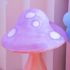 A whimsical, glowing mushroom prop used in a fairy-themed party. These little details help build a magical and immersive environment.